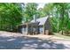 Exterior view of home with glass paneled sunroom and private backyard at 603 Gentry Ln, Hillsborough, NC 27278