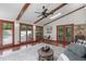 Bright sun room with exposed beams, lots of windows, and ample seating for a relaxing and airy atmosphere at 603 Gentry Ln, Hillsborough, NC 27278