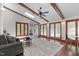 Bright sun room with exposed beams, many windows, and a cozy seating area perfect for lounging and enjoying natural light at 603 Gentry Ln, Hillsborough, NC 27278