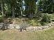 Landscaped backyard features stone retaining walls and manicured plants at 606 Chalice St, Durham, NC 27705