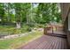 Enjoy the outdoors on the wooden deck overlooking the lush backyard with mature trees and landscaped garden beds at 606 Chalice St, Durham, NC 27705