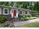 Close-up of the home's entrance with a bright red door and decorative landscaping at 606 Chalice St, Durham, NC 27705