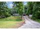 Charming single-story home with a lush, green front yard and mature trees providing shade at 606 Chalice St, Durham, NC 27705