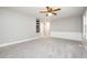 View of the living room featuring light walls, neutral carpet, recessed shelves and base trim at 606 Chalice St, Durham, NC 27705