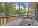 Back deck featuring outdoor furniture overlooking mature trees and partial shade at 640 St Vincent Dr, Holly Springs, NC 27540