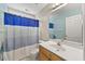 Bathroom with a vanity, sink, toilet, and a bathtub with a blue and white striped curtain at 640 St Vincent Dr, Holly Springs, NC 27540