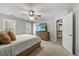 Neutral toned bedroom with plush carpet, dresser, and doorway leading to the staircase at 640 St Vincent Dr, Holly Springs, NC 27540