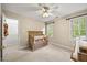 Cozy Bedroom room with crib, closet, and window providing natural light at 640 St Vincent Dr, Holly Springs, NC 27540