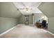 Spacious carpeted bedroom area with a vaulted ceiling and multiple windows providing natural light at 640 St Vincent Dr, Holly Springs, NC 27540