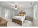 Relaxing bedroom features neutral tones, a ceiling fan, and a comfortable wooden bed frame at 640 St Vincent Dr, Holly Springs, NC 27540
