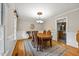 Traditional dining room with hardwood floors, a chandelier, and views into the kitchen at 640 St Vincent Dr, Holly Springs, NC 27540