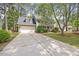 Attractive two-story home with attached garage, front porch, long driveway, and mature trees at 640 St Vincent Dr, Holly Springs, NC 27540