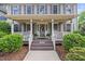 Close up of the front porch featuring rocking chairs and a lovely wreath on the front door at 640 St Vincent Dr, Holly Springs, NC 27540
