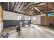 Finished garage with workout equipment, ceiling fan, pegboard and natural light at 640 St Vincent Dr, Holly Springs, NC 27540