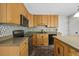 Well-lit kitchen with an island and stainless steel appliances at 640 St Vincent Dr, Holly Springs, NC 27540