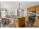 Open kitchen with breakfast bar and view into the living room at 640 St Vincent Dr, Holly Springs, NC 27540