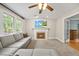 Cozy living room features a fireplace, ceiling fan and plenty of natural light at 640 St Vincent Dr, Holly Springs, NC 27540