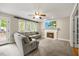 Cozy living room featuring a fireplace, plush carpeting, neutral walls, and an airy ceiling fan at 640 St Vincent Dr, Holly Springs, NC 27540
