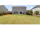 Spacious backyard featuring lush lawn, patio, and well-maintained landscaping, as well as tall privacy fences at 713 Apalachia Lake Dr, Fuquay Varina, NC 27526