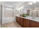 Well-lit bathroom with double vanity, garden tub, and modern fixtures, with updated tile floors at 713 Apalachia Lake Dr, Fuquay Varina, NC 27526