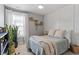 Cozy bedroom with decorative wall, ceiling fan, and large window for natural light with plants at 713 Apalachia Lake Dr, Fuquay Varina, NC 27526
