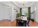 Elegant dining room featuring wainscoting, tray ceiling, and modern light fixture at 713 Apalachia Lake Dr, Fuquay Varina, NC 27526