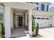 Inviting entrance with a covered porch, stone accents, and an attached two-car garage at 713 Apalachia Lake Dr, Fuquay Varina, NC 27526