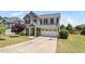 Attractive two-story home with a basketball hoop, manicured lawn, and an attached two-car garage at 713 Apalachia Lake Dr, Fuquay Varina, NC 27526
