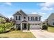 Charming two-story home featuring a manicured lawn, two-car garage, and inviting front porch at 713 Apalachia Lake Dr, Fuquay Varina, NC 27526