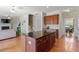 Kitchen with granite island, hardwood floors, and open layout connecting to living room and dining area at 713 Apalachia Lake Dr, Fuquay Varina, NC 27526