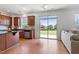 Open kitchen with stainless steel appliances, granite countertops, and a sliding glass door to the backyard at 713 Apalachia Lake Dr, Fuquay Varina, NC 27526