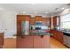 Kitchen featuring granite countertops, stainless steel appliances, hardwood floors, and island with breakfast bar at 713 Apalachia Lake Dr, Fuquay Varina, NC 27526