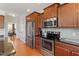 Kitchen featuring granite countertops, stainless steel appliances, and plentiful cabinet space at 713 Apalachia Lake Dr, Fuquay Varina, NC 27526
