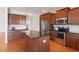 Kitchen featuring granite countertops, stainless steel appliances, hardwood floors, and island with breakfast bar at 713 Apalachia Lake Dr, Fuquay Varina, NC 27526