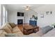 Inviting living room featuring a fireplace, hardwood floors, a ceiling fan, and a comfortable sofa at 713 Apalachia Lake Dr, Fuquay Varina, NC 27526