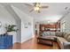 Spacious living room with hardwood floors, a fireplace, and an open view of the kitchen at 713 Apalachia Lake Dr, Fuquay Varina, NC 27526