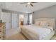 Comfortable primary bedroom with tray ceilings, neutral tones and an ensuite bathroom in view at 713 Apalachia Lake Dr, Fuquay Varina, NC 27526