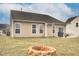 Spacious backyard featuring a fire pit, patio with a grill and a table set, and ample space for outdoor activities at 74 Hidden Grove Ct, Garner, NC 27529