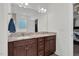 Bathroom with double sink vanity, granite countertop, tile flooring, and large mirror at 74 Hidden Grove Ct, Garner, NC 27529