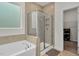 Bathroom featuring tile flooring, glass shower, bathtub and frosted window at 74 Hidden Grove Ct, Garner, NC 27529
