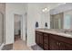 Bathroom with double sink vanity, granite countertop, tile flooring, and large mirror at 74 Hidden Grove Ct, Garner, NC 27529