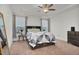 Comfortable bedroom with tray ceiling, carpet, and large windows at 74 Hidden Grove Ct, Garner, NC 27529