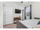 Modern bedroom with plush carpet, lots of natural light, and a mounted television at 74 Hidden Grove Ct, Garner, NC 27529