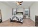 Comfortable bedroom with tray ceiling, carpet, and large windows at 74 Hidden Grove Ct, Garner, NC 27529