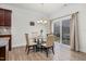 Dining area with a glass table and neutral colored chairs, next to sliding glass doors to patio at 74 Hidden Grove Ct, Garner, NC 27529