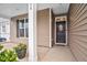 Inviting front porch featuring decorative wreath, dark door and concrete flooring at 74 Hidden Grove Ct, Garner, NC 27529