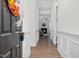 Hallway leading to the living area with hardwood floors and white decorative molding at 74 Hidden Grove Ct, Garner, NC 27529