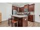 Gourmet kitchen features granite countertops, stainless appliances, dark wood cabinets and a center island with seating at 74 Hidden Grove Ct, Garner, NC 27529