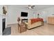 Bright living room features a fireplace, ceiling fan, neutral paint, and wood-look flooring at 74 Hidden Grove Ct, Garner, NC 27529