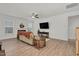 Cozy living room features a fireplace, ceiling fan, neutral paint, and wood-look flooring at 74 Hidden Grove Ct, Garner, NC 27529